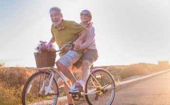 retired couple riding a bike together