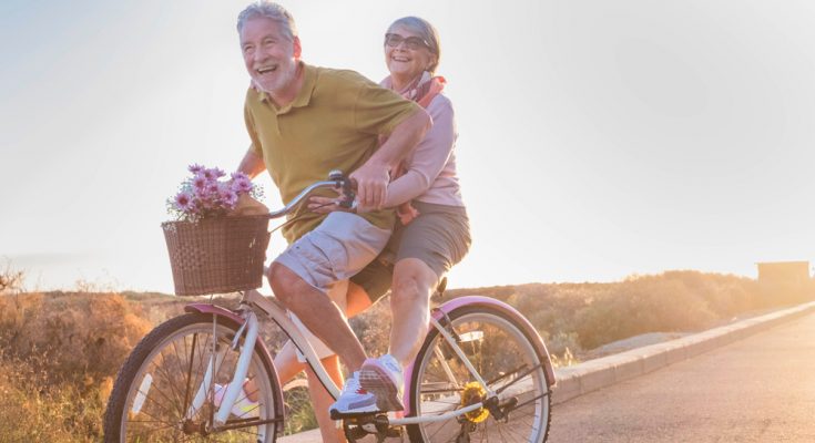 retired couple riding a bike together